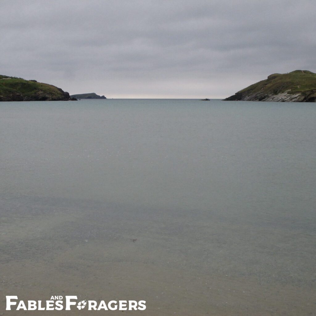 calm bay with horizon line shading into cloudy sky