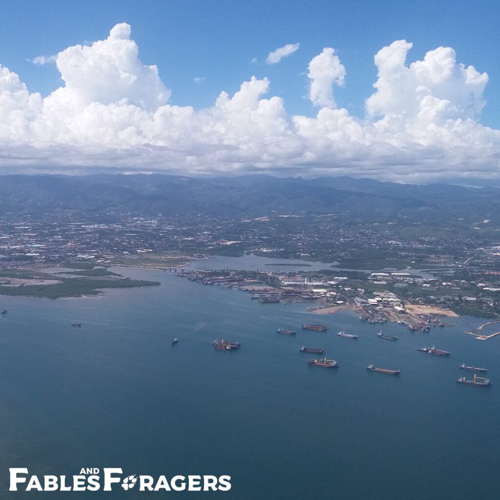 aerial view of urban docks with mountains and giant clouds in background